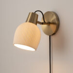 Petaluma Bone Porcelain Wall Sconce with Weathered Brass Accents by Nova of California.
